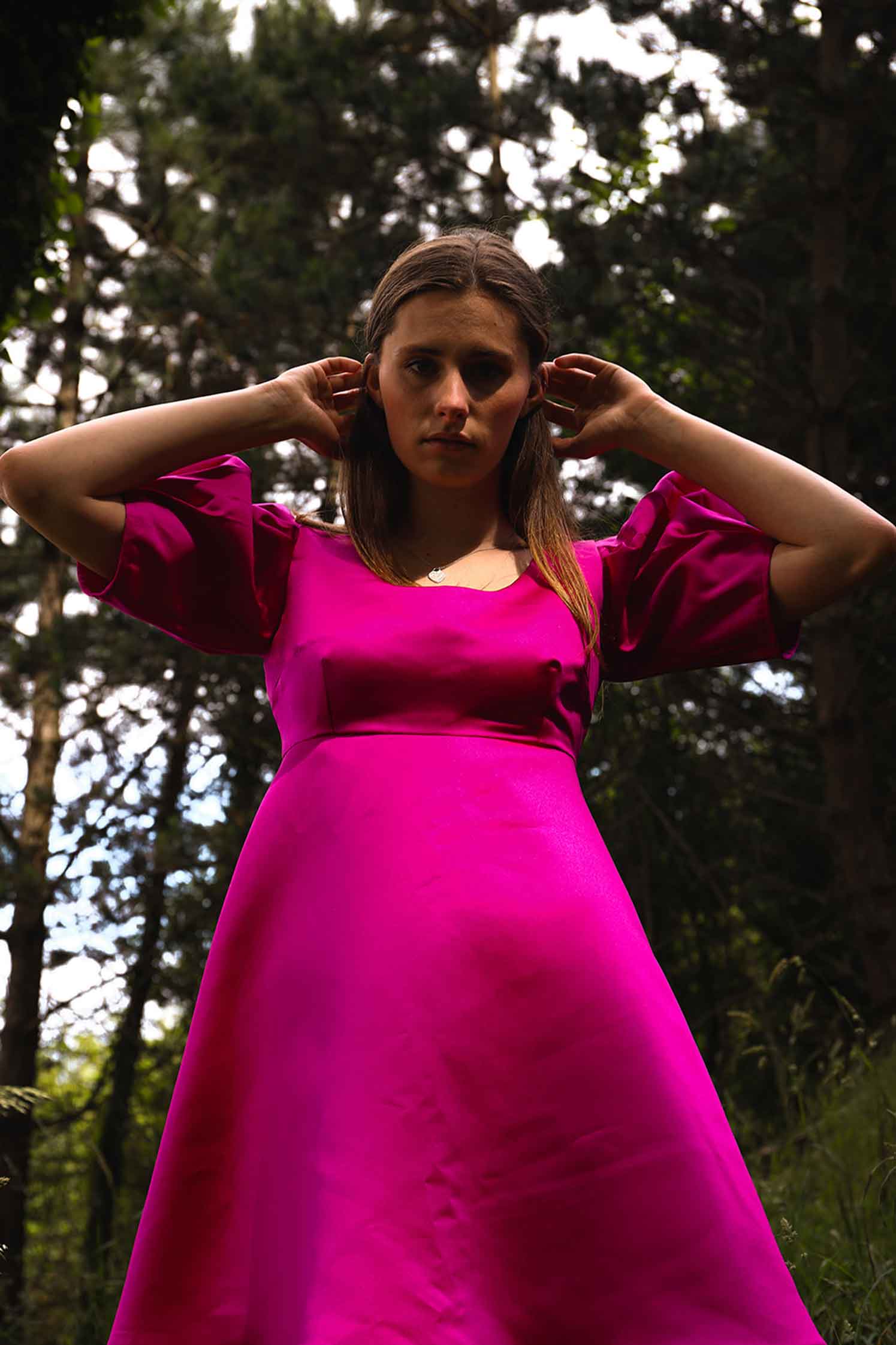pink satin dress with an empire waistline and puff short sleeves