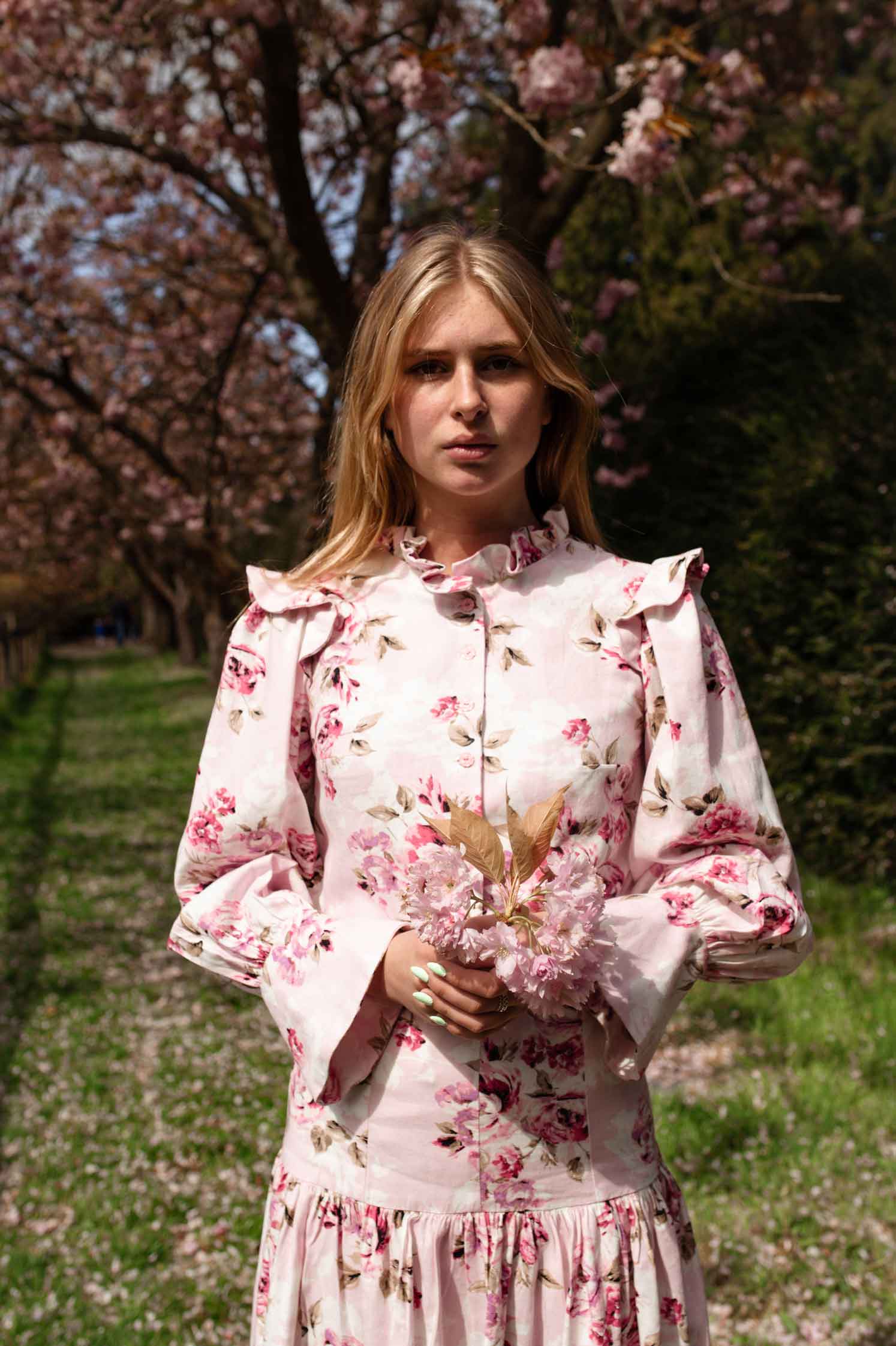 pink floral blouse with fluted cuffs and ruffle shoulders and collar. button up front linen shirt. Ladies office wear.