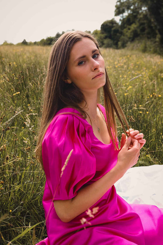 hot pink satin mini dress with pleated puff sleeves.